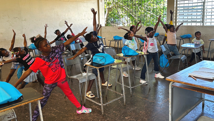 Children practicing a calming ‘Star Stretch’ during a Bahali workshop.